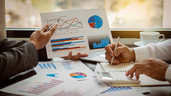 Two,Business,People,Working,Together,To,Analyze,,Work,Together,To