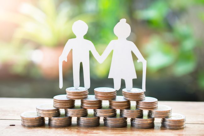 Couple,Older,Model,Standing,On,Money,Coins,Saving,For,Concept