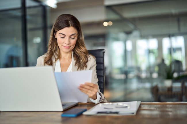 Busy,Mid,Aged,Business,Woman,Working,In,Office,With,Laptop